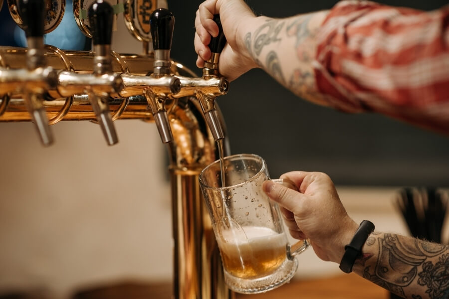 guy pouring beer from a tap